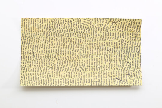 Beige decorative paper with a subtle repeating geometric pattern for minimalist stationery and crafts.