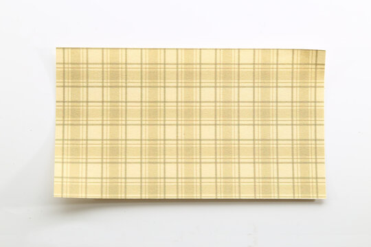 Beige and cream plaid paper with a subtle checkered design for rustic crafts and elegant stationery.