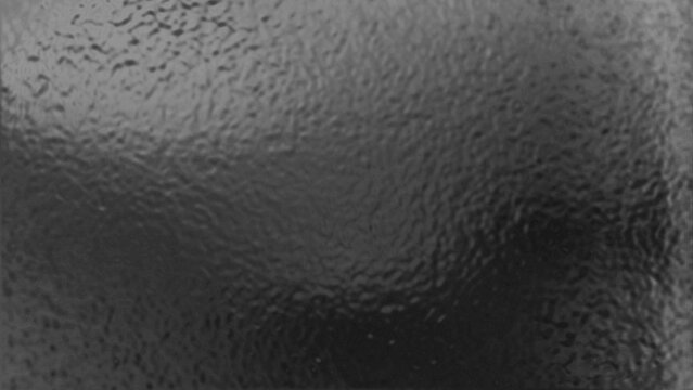 Abstract dark gray textured background with a subtle ripple or hammered metal effect