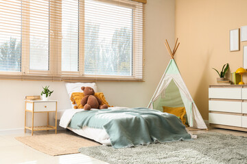 Childhood development and nursery interior, cozy bedroom with teepee tent and bed for kids in modern home with natural light and minimalist decor © Pixel-Shot