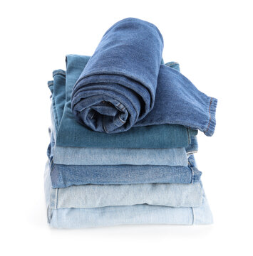 Sustainable fashion and clothing organization, stack of folded blue denim jeans and rolled pants for wardrobe storage or retail apparel collection