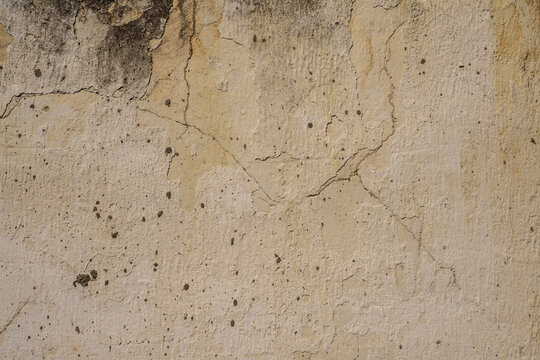 Fondo de textura de pared antigua agrietada, estuco grunge beige con cemento desgastado y manchas