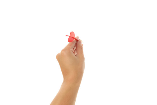 Hand displays a red toothpick topper for party use, isolated on white, PNG