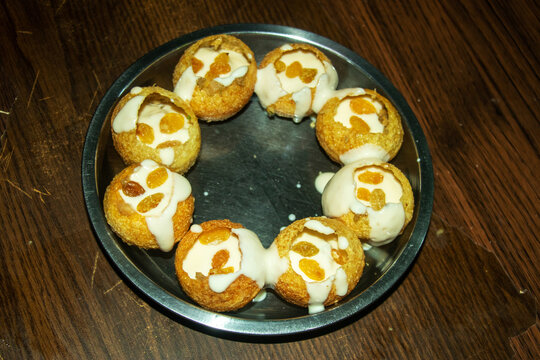 Delicious dahi puri snack with white yogurt and sweet raisins
