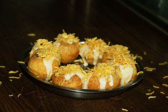 Traditional dahi puri snack topped with crunchy golden sev