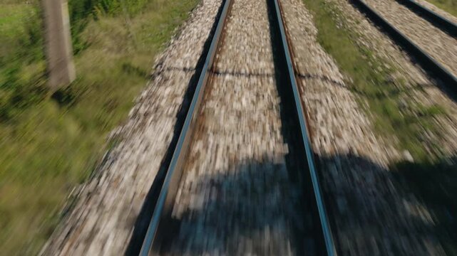 Parallel Railway Tracks Through Grassy Landscape