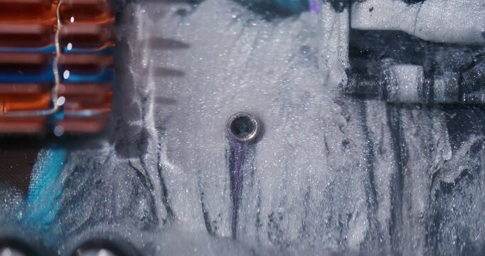 Ink wave. Digital hardware. Defocused white blue orange color glitter texture round cpu shiny water fog cascade on abstract art background.