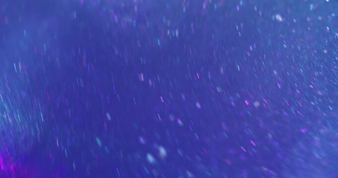 Defocused kaleidoscope. Glitter texture. Blue purple color round illuminated luminous circling on abstract creative art background.