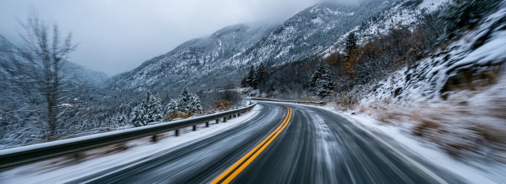 Curvy winter road through snow-covered mountains in overcast weather  
