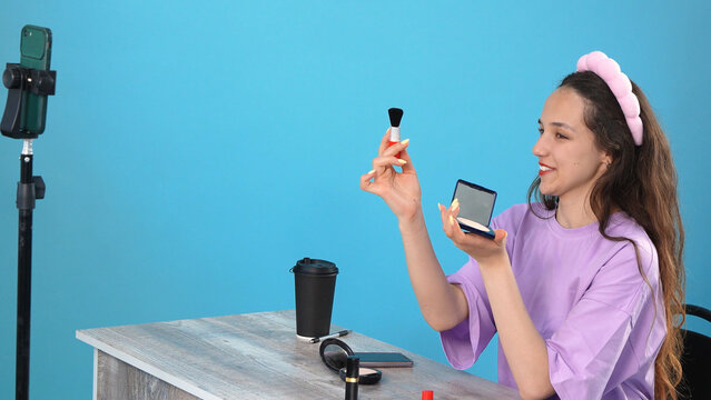 Young Beauty Vlogger Recording Makeup Tutorial on Phone in Studio