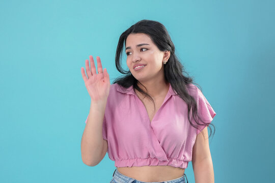 Skeptical Young Woman with Braces Making a Stop Gesture