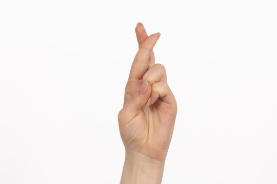 Hand with Fingers Crossed for Luck and Hope on White Background