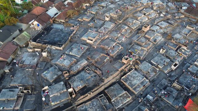 Aerial view of Sade Village with traditional houses and people walking in Pujut, West Nusa Tenggara, Indonesia.