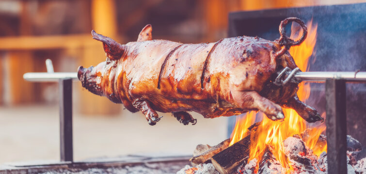 Whole pig roasting on a spit over a vibrant open fire, preparing traditional barbecue food for a celebration