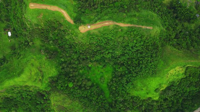 Aerial landscape view of Quitinday Hills in Albay, Philippines, capturing layers of green rolling hills and the surrounding countryside of the Bicol Region.