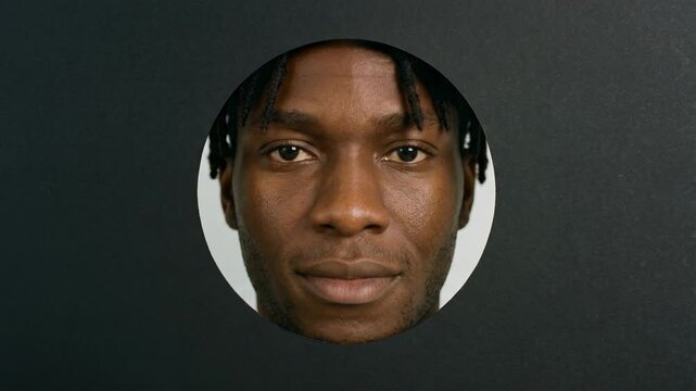 Close-up portrait of a young Black man with dreadlocks and headphones