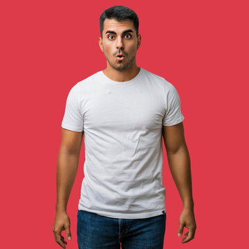 Man young t shirt face surprise expression, shocked shock and excited yet afraid &mdash; studio portrait of a startled, bearded young adult showing amazement, fear and disbelief