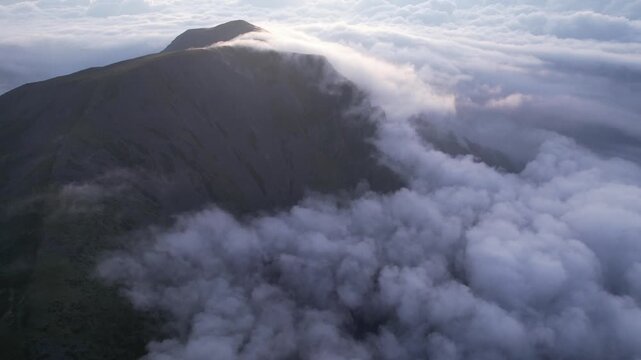 Aerial Drone Footage of a Western Sichuan Mountain Peak Rising Above a Sea of Clouds at Sunrise