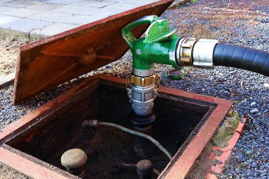 Refilling heating oil in an underground storage tank.