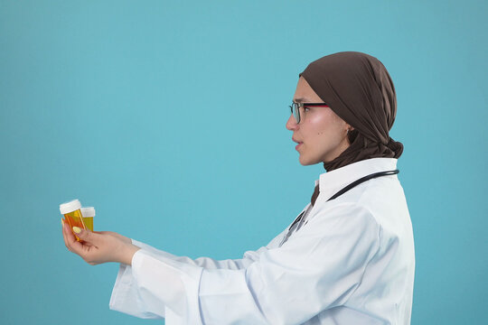 Muslim Female Doctor Profile Holding Prescription Pill Bottles
