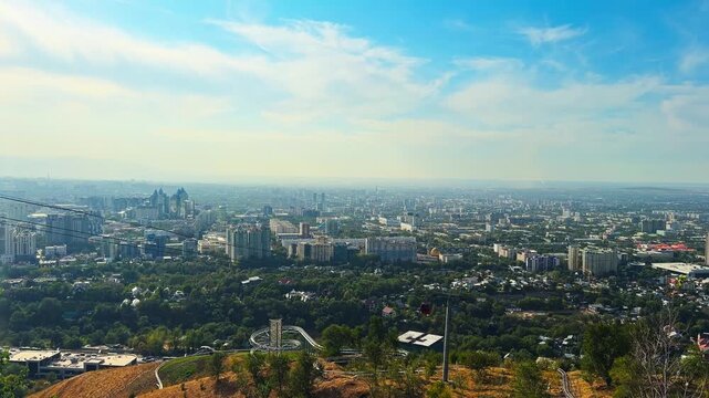 Cable Car Across The Cityscape From Kok Tobe Park In Almaty, Kazakhstan. Aerial Pan-Right Shot