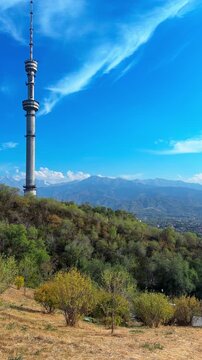 Steel Telecommunications And Observation Landmark Of Almaty On The Slopes Of Kok Tobe Mountain In Kazakhstan. Vertical, Panning Shot