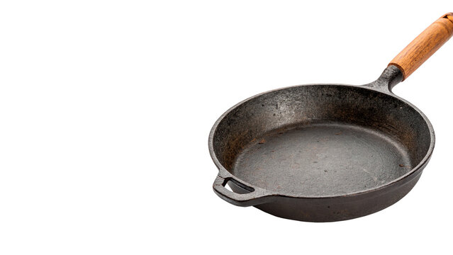 Classic black cast iron skillet frying pan wooden handle, isolated on transparent background.