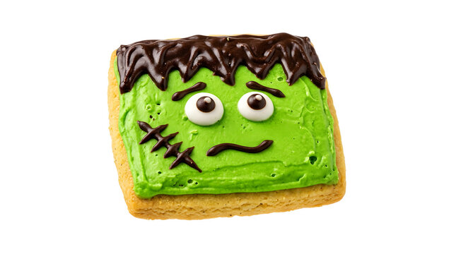 A square sugar cookie decorated with green frosting and chocolate icing to look like frankensteins monster, isolated on transparent background