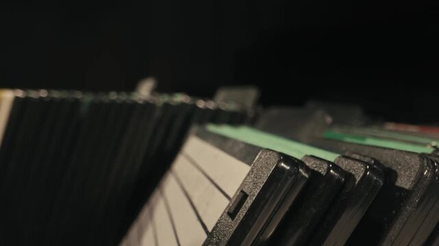 Close up of hand browsing through vintage floppy disks in storage case