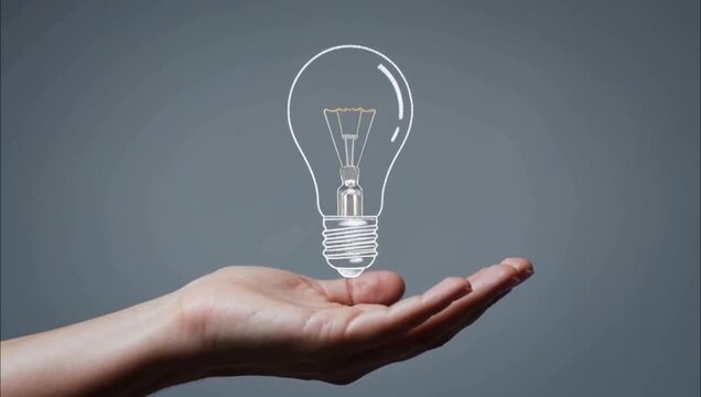 Human hand holding a glowing lightbulb symbol representing innovation and creative business ideas.