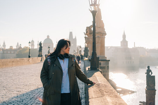 Korean tourist enjoys sunny day while exploring Prague on bridge