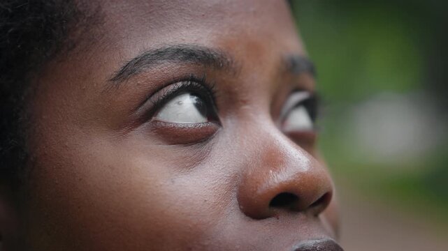 African american ethnicity, closeup on female face, black eyes and dark skin. Portrait of beautiful black woman outdoors, emotions and face expression, autumn melancholy and thoughts, good vision
