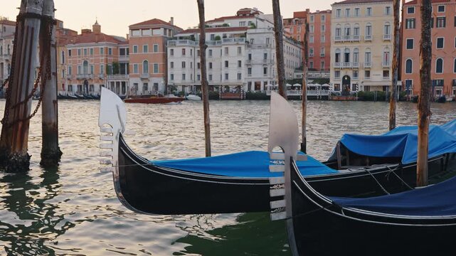 Gondola metal bow ferro close up with Grand Canal and Venetian palaces on background at sunset slow motion Venice Italy stock footage