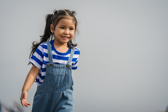 preschool child girl walking on a road on mountain in morning