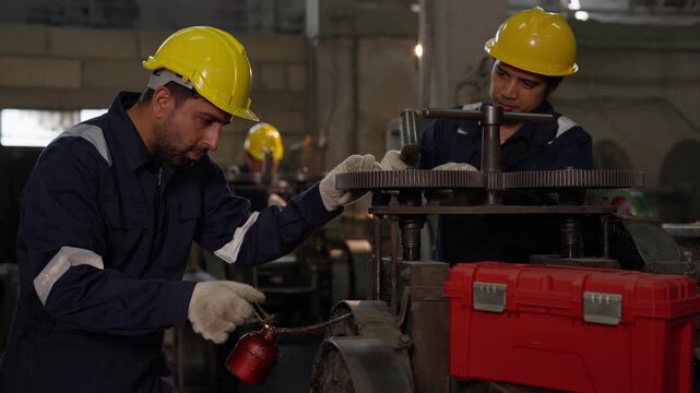 Industrial Engineer Inspection of Factory Machinery with Focused Workers in Helmet Performing Safety Maintenance, Repairing Heavy Equipment and Handling Red Tool Case in Workshop