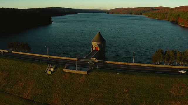 Barkhamsted Reservoir in Connecticut glowing with fall foliage colors at a stunning sunset