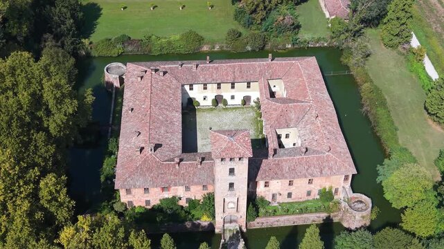 Aerial view of Castello di Peschiera Borromeo surrounded by a moat and lush greenery in Peschiera Borromeo, Lombardia, Italy.