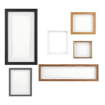 Various empty wooden and metal picture frames arranged on a plain white wall with art home decor gallery interior design living room frame