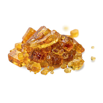 Amber resin crystals pile isolated on white background with still life cut out ambergris fragrance material gemstone transparent translucent