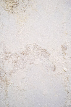 Textured white wall with subtle stains and imperfections.