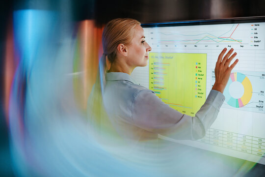Businesswoman analyzes data on a modern digital screen