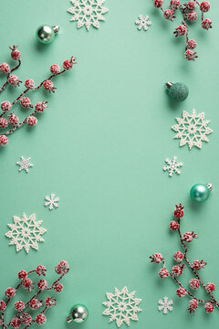 Merry Christmas teal holiday vertical flat lay with snowflake ornaments, frosted berries and Happy New Year accents