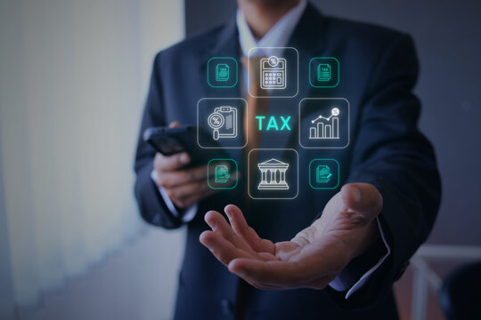 Businessman Holding Smartphone while Displaying Hologram Tax Document Icons