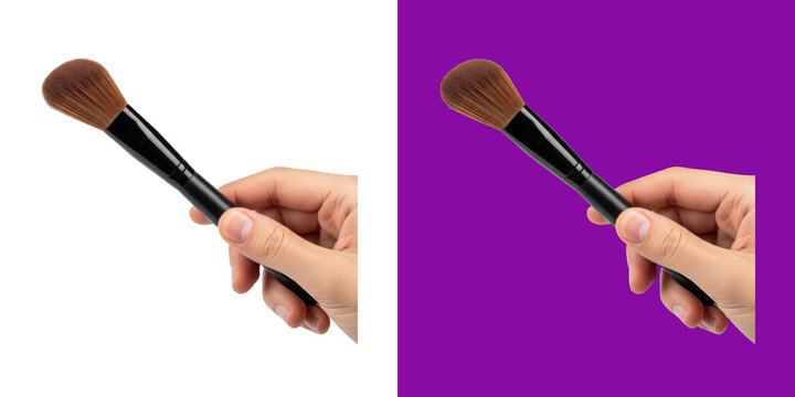 A hand holding a professional makeup brush for facial cosmetics application