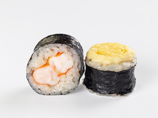 Two maki sushi rolls with shrimp filling and creamy yellow topping on white background, Japanese cuisine close up as Asian bistro food © Andrei Starostin