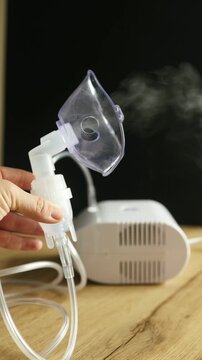 Compressor nebulizer operating and producing a fine mist, demonstrating the function of an inhalation therapy device.

