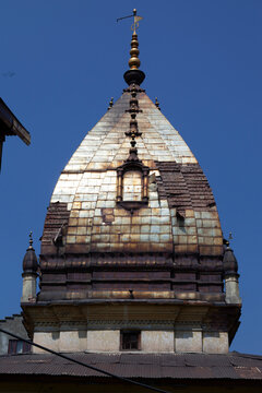 Ornate metal clad spire of the Raghunath Hindu temple against a deep blue sky, Jammu and Kashmir, Srinagar, India