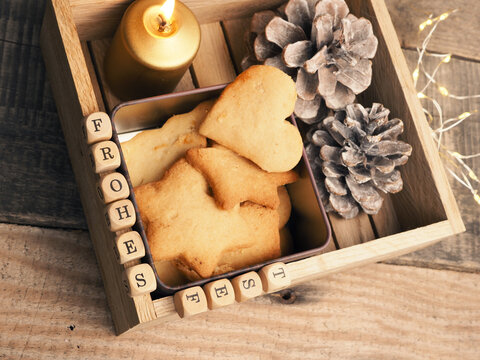 Small wooden block with the German words Frohes Fest and Christmas decoration