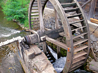 Old wooden water mill wheel over a rushing stream in Rosia village, Apuseni Mountains, Bihor, Romania © MoodAmi Studio