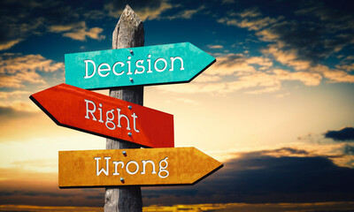 Decision, right, wrong - colorful wooden signpost with three arrows, sunset sky © PX Media